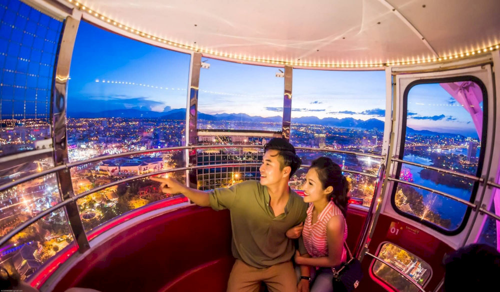 The view becomes magical with the city illuminated by countless lights, creating a dazzling, sparkling night scene